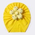 Detailed view of yellow ribbed baby turban featuring a large white daisy flower pattern - Yellow