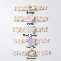Detail view of five colors of lace baby headbands including pink, mint and beige floral styles - Mixed Colors
