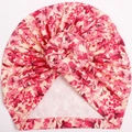 Close-up of floral print baby turban hat with decorative center knot and ribbed fabric - Pink Floral