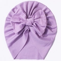 Close-up of lavender ribbed knit baby turban featuring a large decorative bow - Purple