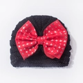 Infant knit beanie in black featuring a large red bow with silver star patterns - One Size / Black