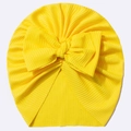 Close-up of bright yellow ribbed knit baby turban hat with a large decorative bow - Yellow
