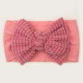 Detail of soft pink waffle texture oversized bow on stretchy newborn baby headband - Dark Mauve