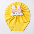 Detailed view of yellow ribbed baby hat featuring a 3D plush white bunny with pink bow - Yellow