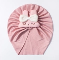 Detail of pink ribbed baby hat with cute rabbit patch and large white bow decoration - Nude Pink