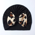 Detail of baby black ribbed knit hat featuring a large leopard print bow on white background - Black