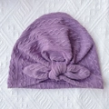 Detail of purple ribbed knit baby hat with rabbit ear knot and soft braided texture - Taro Purple