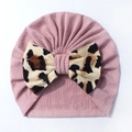 Detail of baby pink ribbed knit turban hat featuring a large leopard print bow - Taro Purple