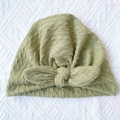 Close-up of olive green ribbed texture and soft knit knot on the infant turban hat - Green