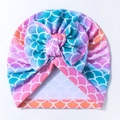 Close-up of baby turban hat featuring colorful fish scale print and a large bow detail - Purple