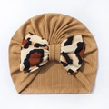 Detail of baby turban hat featuring a leopard print bow and caramel ribbed fabric - Coffee