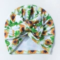 Close-up of yellow sunflower pattern on white seersucker baby hat with large bow detail - Khaki/Earth Yellow