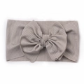 Close-up of soft grey ribbed knit baby headband with a large decorative double bow - Gray