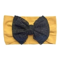 Detailed view of ginger yellow baby headband with large black lace polka dot bow - Earthy Yellow