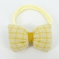 Detailed view of yellow plaid bow baby headband with elastic seamless nylon band - Beige