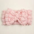 Detail of soft pink seersucker baby headband with a large decorative bow - Snow Bud