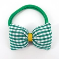 Detail of green gingham bow hair tie with yellow center knot and elastic nylon band - Green