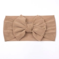 Close-up of soft mesh baby headband with a large bow in apricot color for infants - Light Coffee