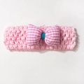 Close-up of pink hollow knit baby headband with a large gingham bow and teal center detail - Pink
