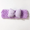 Detail of lavender crochet baby headband featuring a purple and white checkered bow - Purple