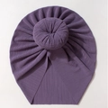 Macro detail of dark purple turban baby hat featuring a soft ribbed donut knot design - Purple
