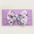Detail of lavender baby nylon headband featuring a large floral print ribbed bow - Purple