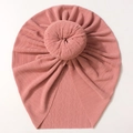 Detailed view of pink ribbed knit baby turban featuring a round donut knot design - Dusty Pink