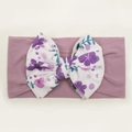 Close-up of wide nylon baby headband with floral print bow and soft knit texture - Taro Purple