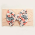 Detailed close-up of baby nylon headband with floral bow and soft elastic ribbed fabric - Nude Pink