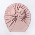 Detail of baby turban hat featuring a large bow and soft pink ribbed cotton texture - Snow Bud