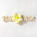 Detail of baby lace headband featuring a yellow fabric flower with soft floral embroidery - Yellow