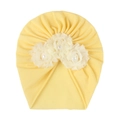 Detail of baby yellow turban featuring three cream fabric flowers and center pearls - Beige