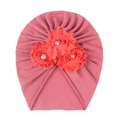 Detail of three soft fabric roses with faux pearls on pink baby beanie hat fabric - Dust Rose