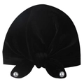 Detail of black velvet baby turban cap featuring a knotted bow with white pearl accents - Black