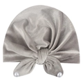 Detail of grey velvet baby turban hat featuring a large bow and white faux pearls - Gray