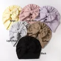 Detail of six textured baby beanies with oversized bows in various soft colors - 6 Colors Mixed