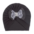 Detail of baby turban hat with gray ribbon, white lace bow, and elegant center pearls - Black