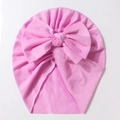 Detail shot of bright pink baby turban hat with oversized bow in soft ribbed cotton - Pink