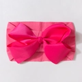 Detailed view of fuchsia grosgrain ribbon bow on a soft elastic baby headband - Rose Red