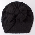Detailed view of black textured knit baby turban hat with a large decorative bow - Black