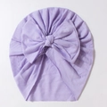 Detail of light purple baby beanie featuring a large bow and soft gathered fabric - Purple