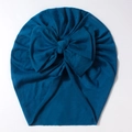 Detailed view of peacock blue baby turban hat with a large bow made of soft ribbed knit cotton - Navy Blue