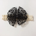 Cute baby headband featuring a large black lace bow with floral embroidery and elastic band - Black