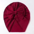 Detailed view of dark red baby turban hat featuring a large knot bow and soft ribbed knit fabric - Burgundy