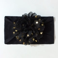 Détail du bandeau pour bébé avec décoration florale en mousseline noire à pois dorés - Noir