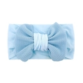 Detailed view of light blue waffle fabric texture and oversized bow on baby headband - Blue