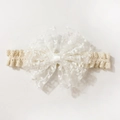 Close-up of white lace bow headband for babies with floral embroidery and mesh detail - White