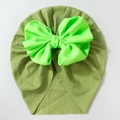Detail of baby turban hat showing dark green ribbed knit fabric and neon green bow - Green