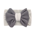 Detail of baby headband featuring soft grey waffle texture fabric and large bow design - Gray