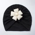 Detail of soft black baby turban hat featuring a large 3D white flower with beaded center - Black